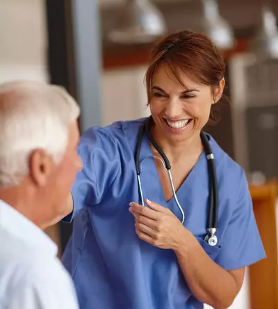 nurse smiling at elderly patient